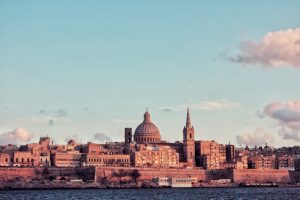 The city of Valletta at sunset photo by micaela parejte on unsplash